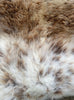 Brown and cream sheepskin rug close up