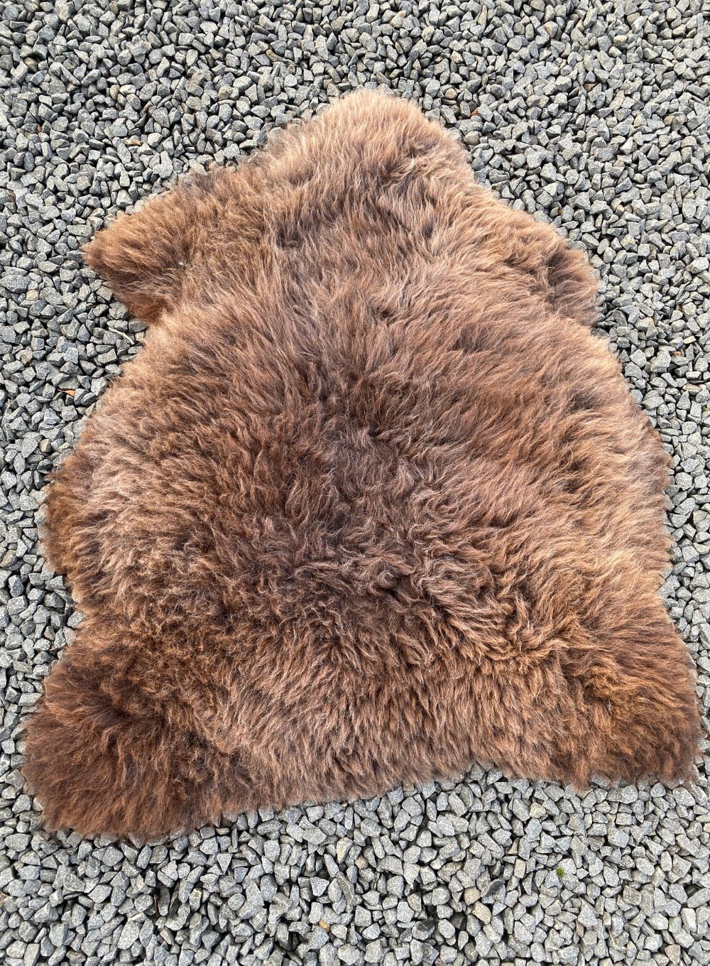 Brown sheepskin rug laid flat 