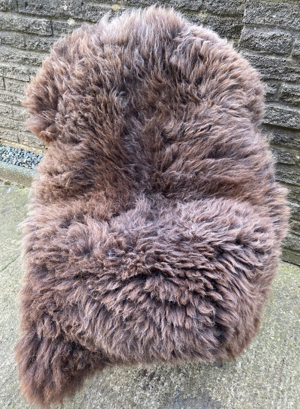 Brown sheepskin rug on chair