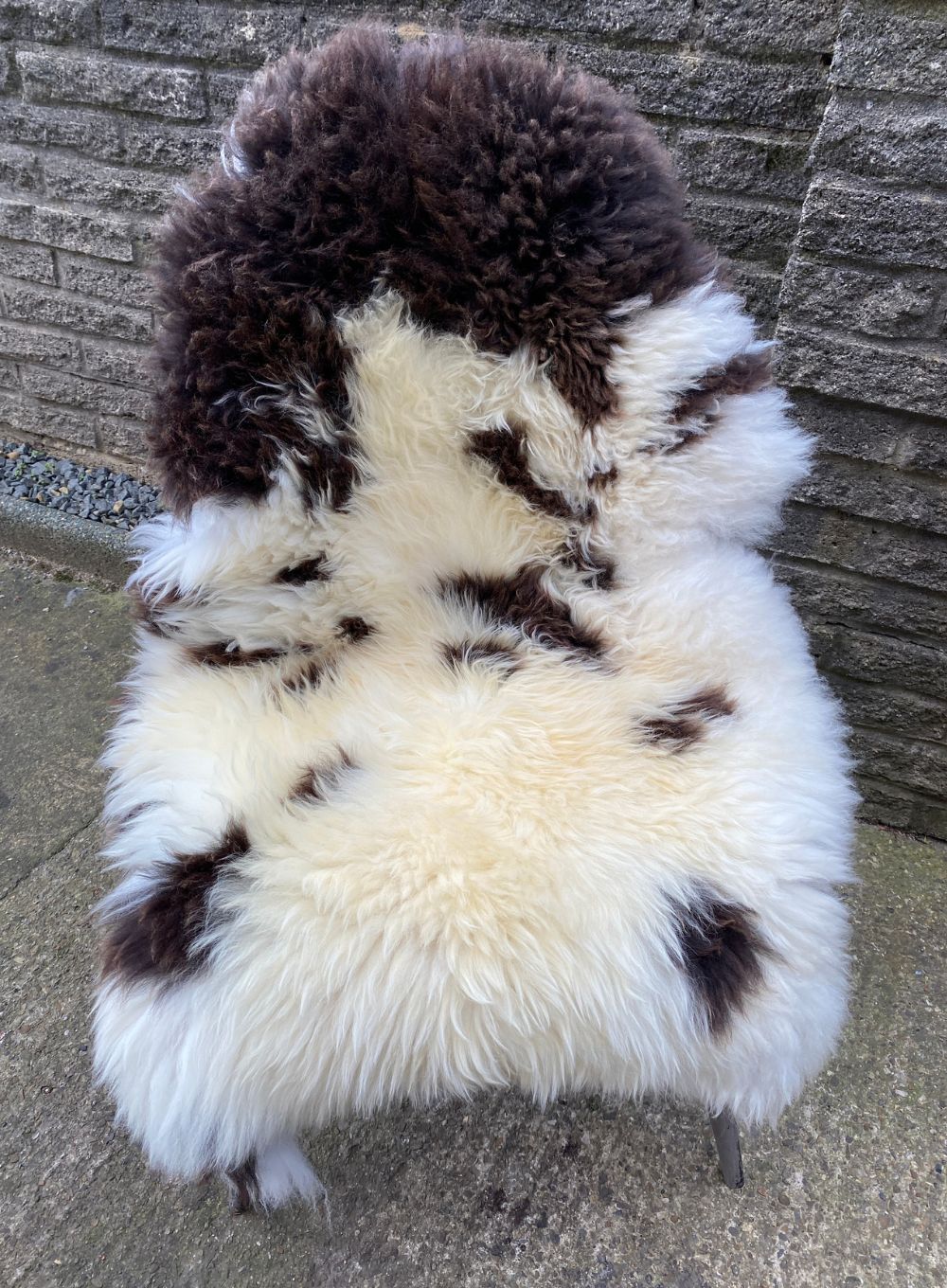 Brown and cream sheepskin rug on chair