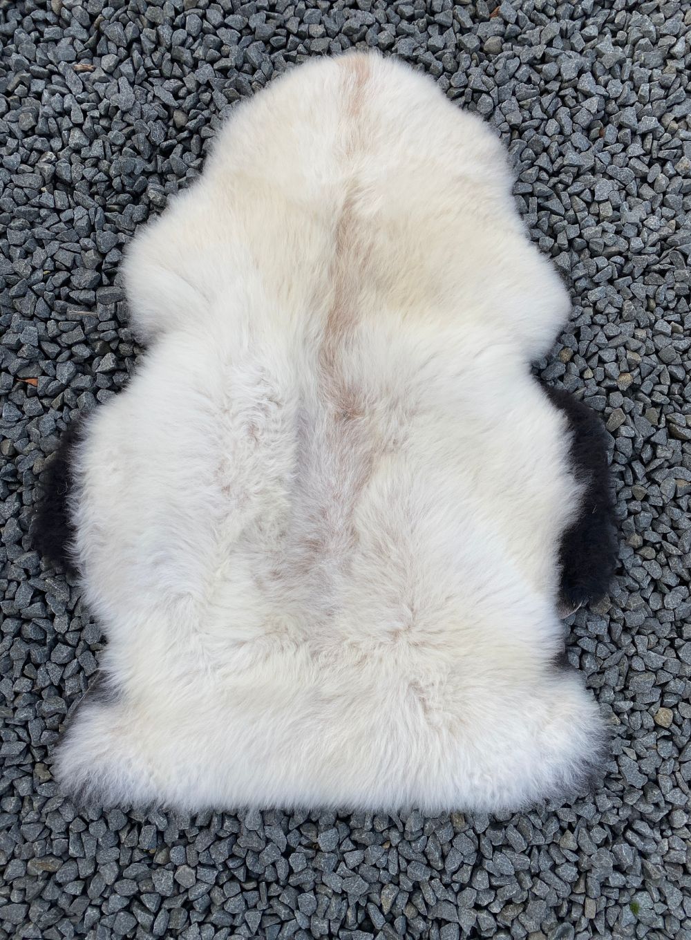 Cream sheepskin rug laid flat