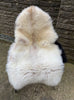 Cream sheepskin rug on chair