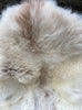Cream sheepskin rug close up 