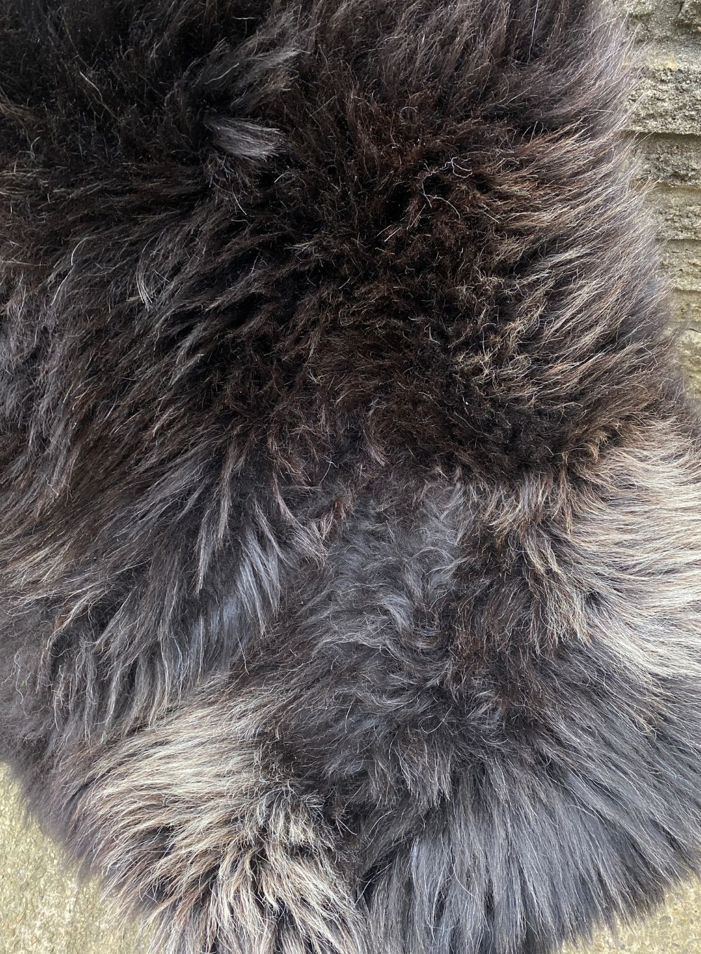 Dark brown sheepskin rug close up 
