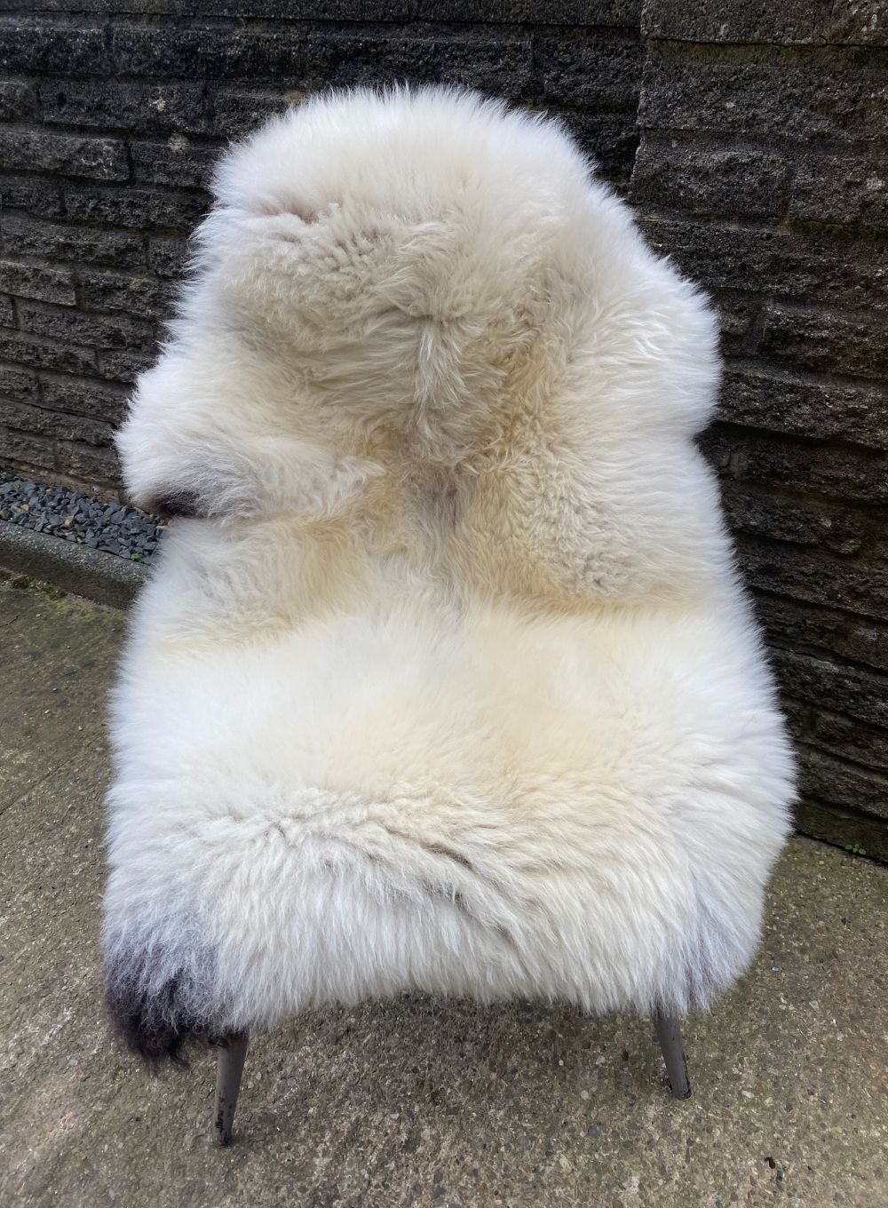 Cream sheepskin rug on chair