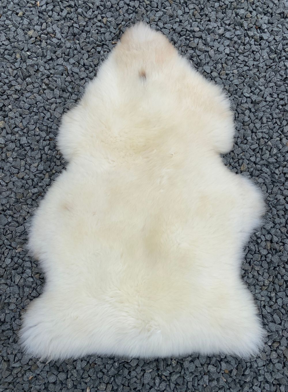 Cream sheepskin rug laid flat