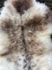 Cream and brown speckled sheepskin rug close up