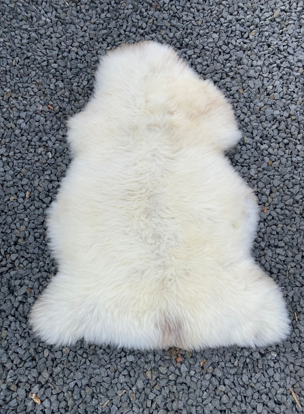 Cream sheepskin rug laid flat