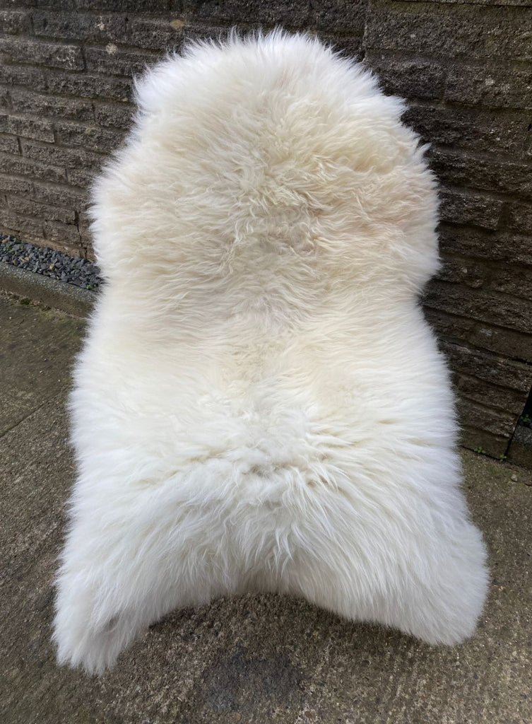 Cream sheepskin rug on chair 