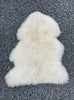 Cream sheepskin rug laid flat