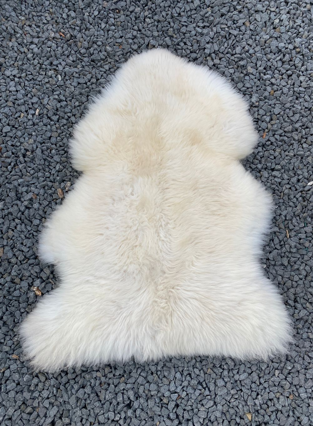 Cream sheepskin rug laid flat