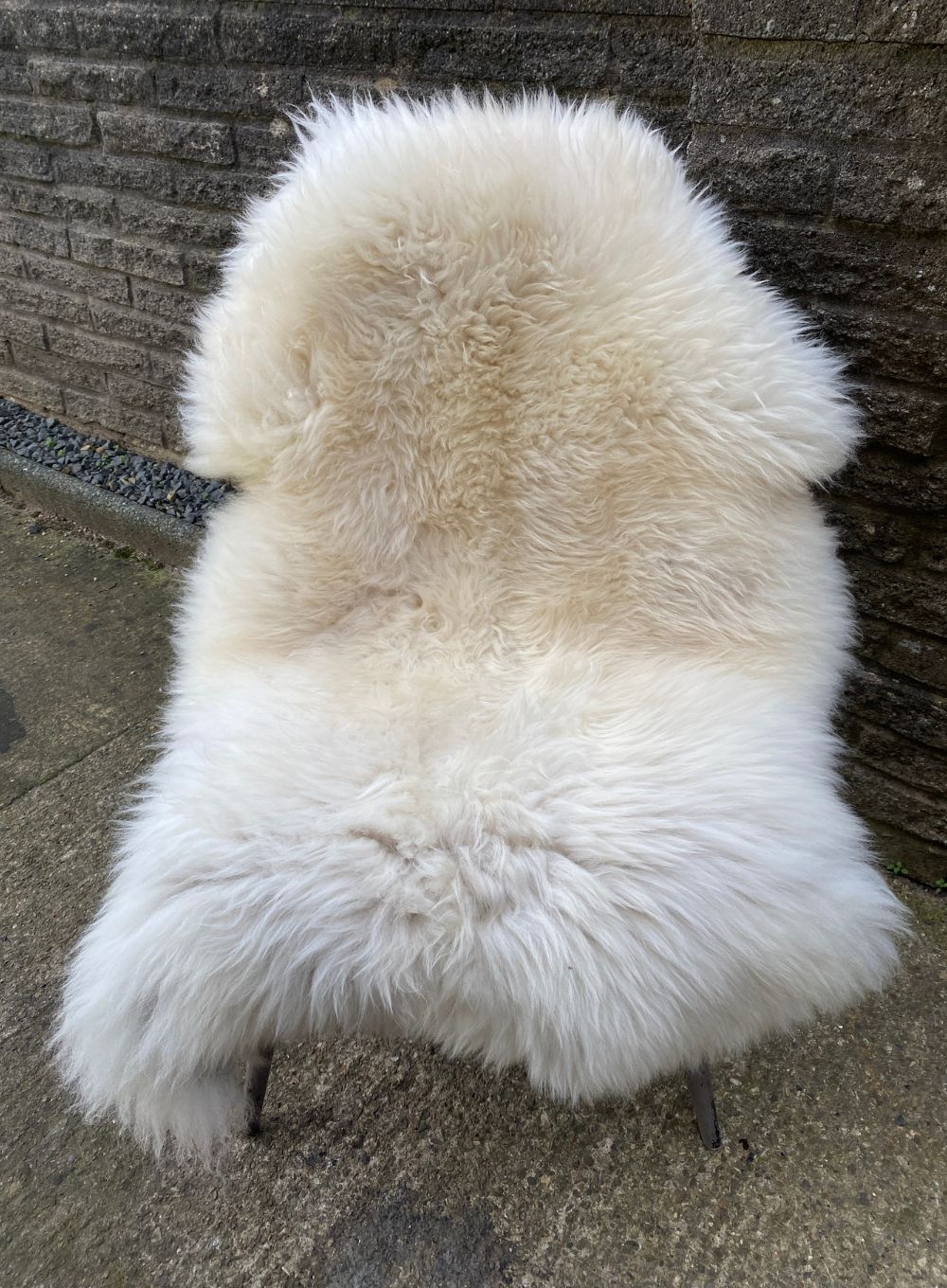 Cream sheepskin rug on chair