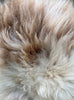 Cream speckled sheepskin rug close up