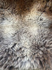 Brown and grey sheepskin rug close up