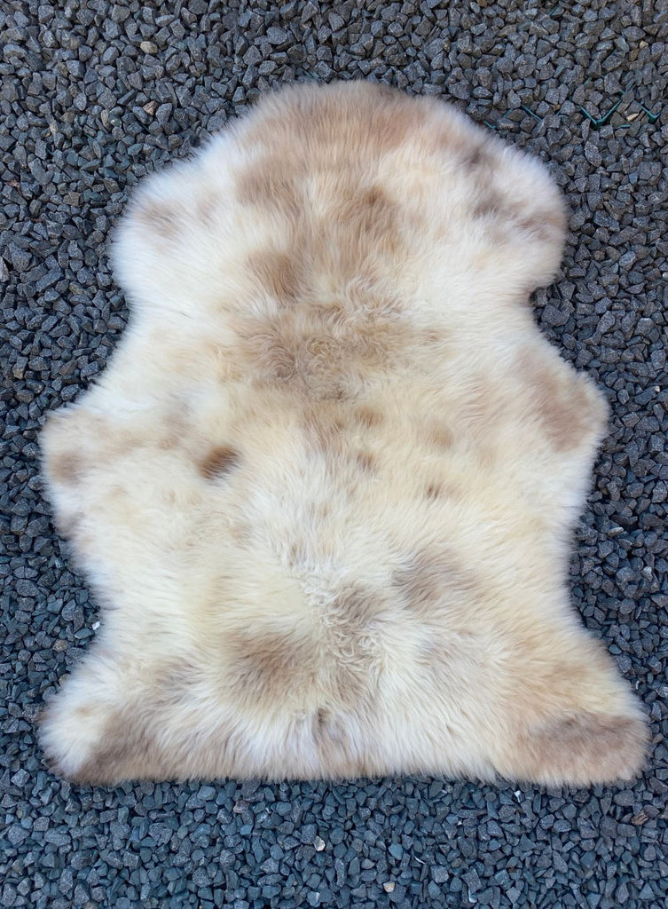 Cream speckled sheepskin rug flat 