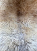 Cream speckled sheepskin rug close up 