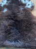 Brown sheepskin rug with cream spots close up