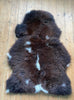 Brown sheepskin with cream spots laid flat