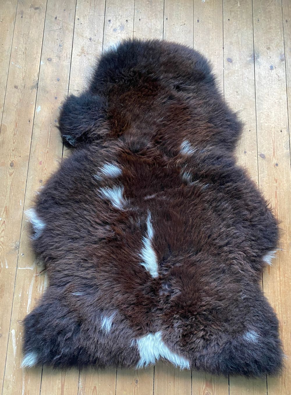 Brown sheepskin with cream spots laid flat