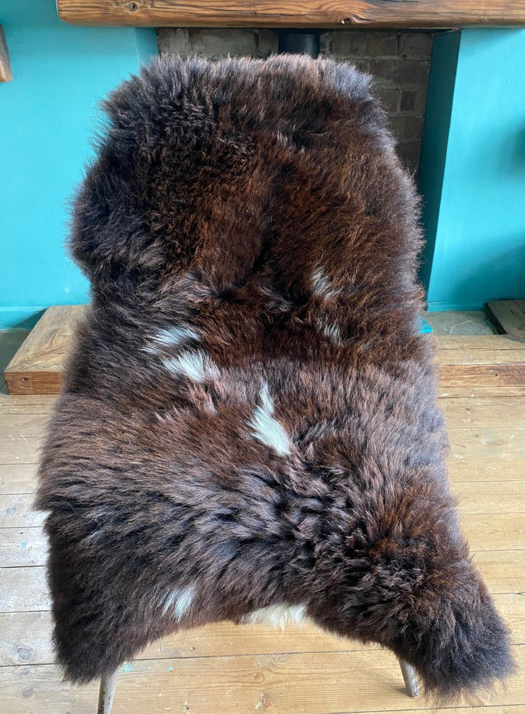 Brown sheepskin with cream spots on chair