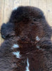 Brown sheepskin with cream spots close up