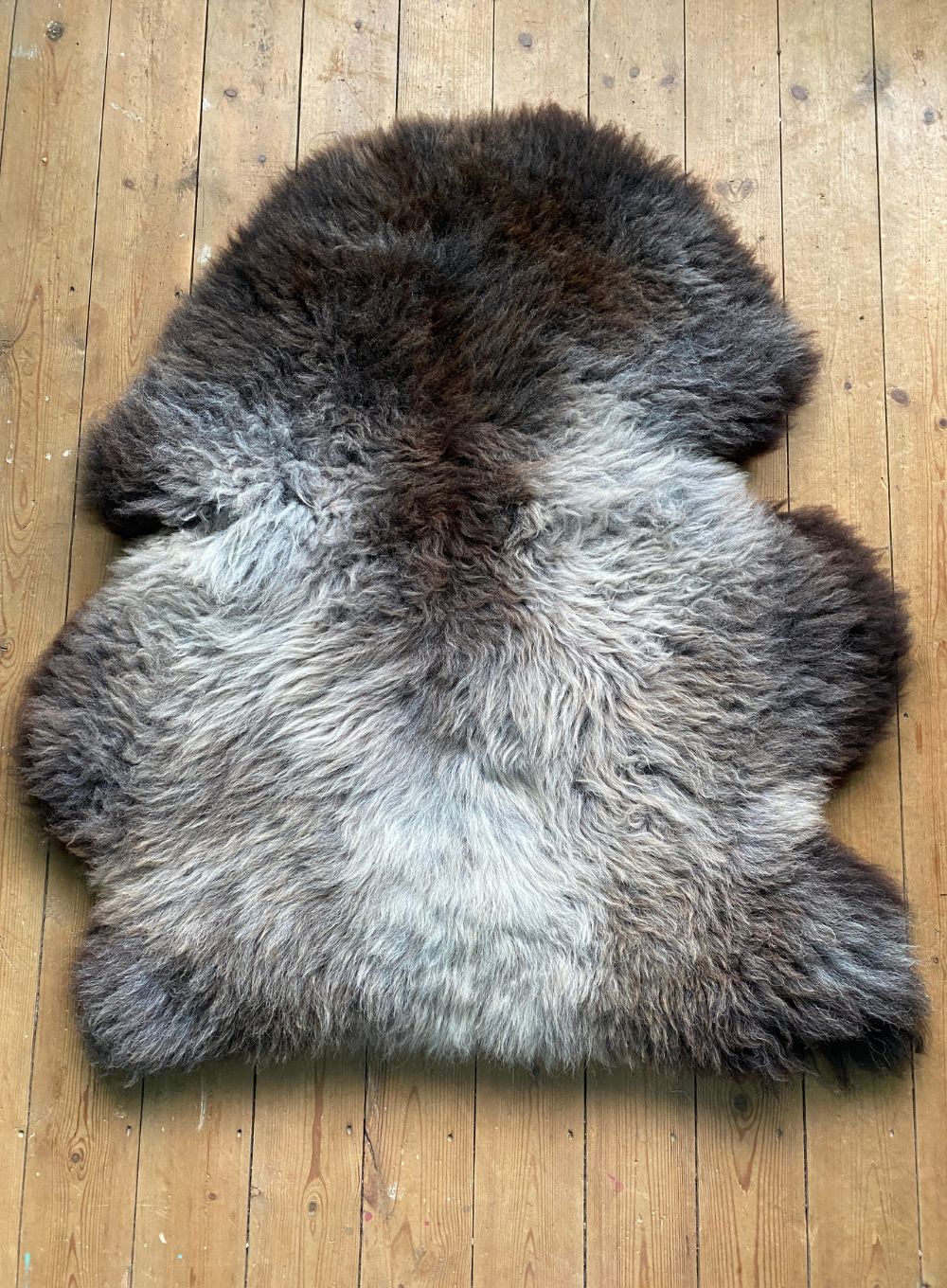 Brown and grey sheepskin rug laid flat 