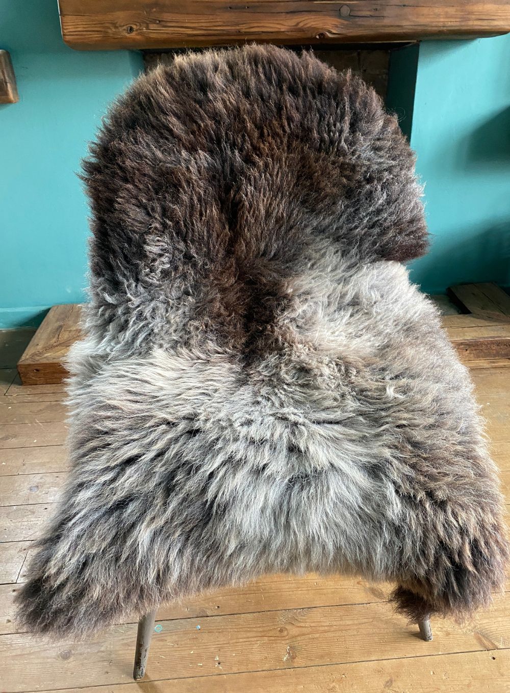 Brown and grey sheepskin rug on chair 