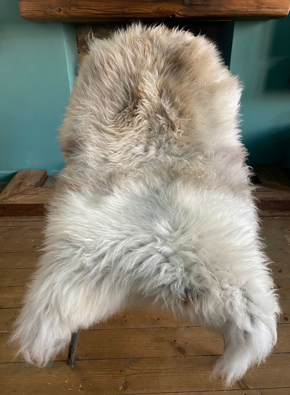 Cream speckled sheepskin rug on chair