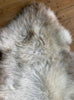 Cream speckled sheepskin rug close up