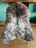 Brown and grey sheepskin rug on chair