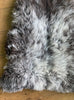 Brown and grey sheepskin rug close up