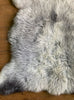 Grey sheepskin rug close up