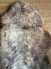 Brown and cream sheepskin rug close up 