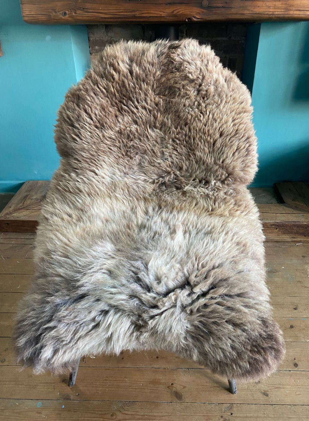 Brown and cream sheepskin rug on chair 