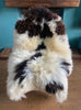 Brown and crem sheepskin rug on chair 