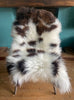 Cream and brown sheepskin rug on chair
