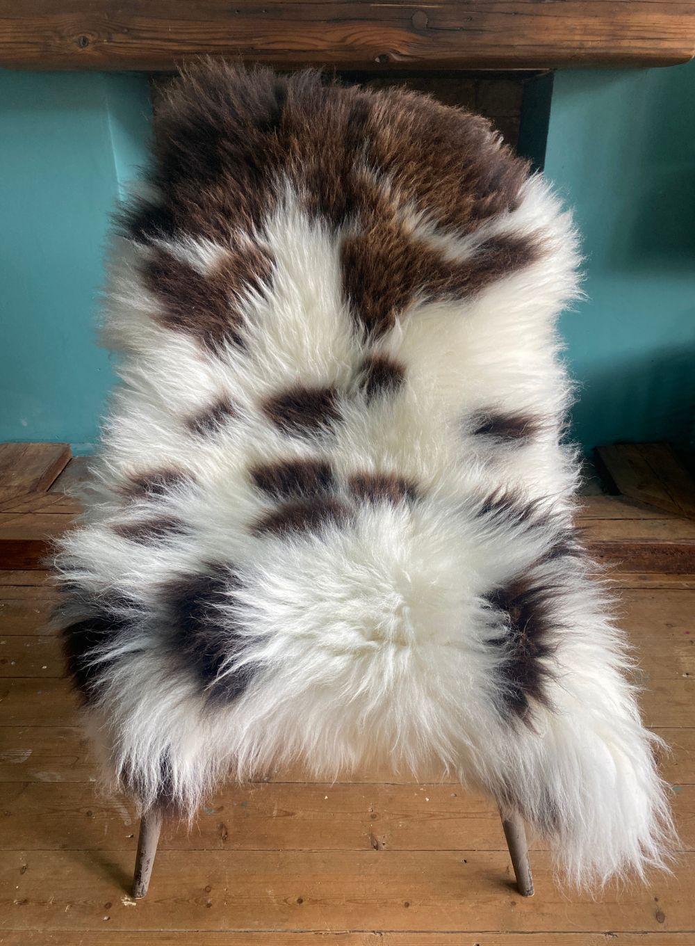 Cream and brown sheepskin rug on chair