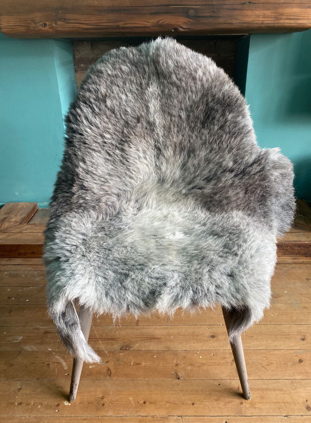 Grey sheepskin rug on chair 