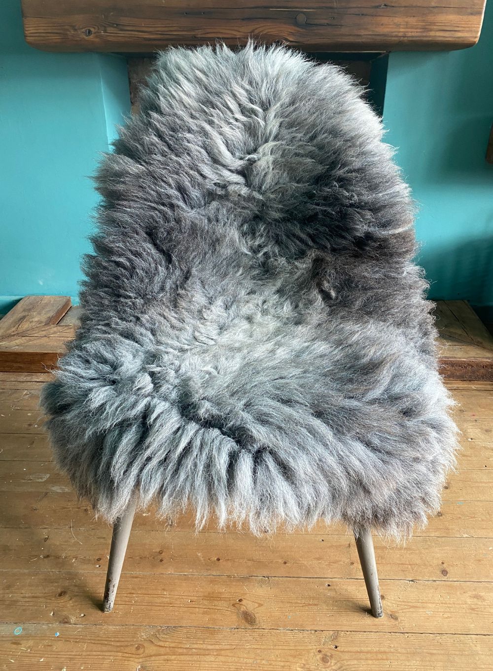 Grey sheepskin rug on chair