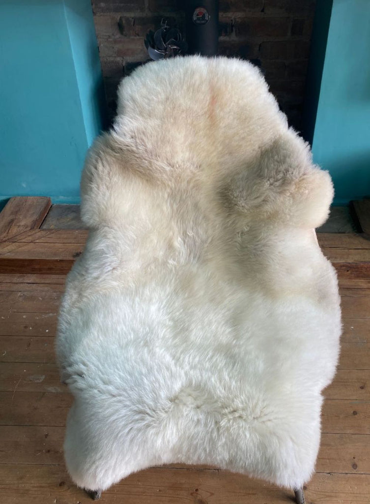 Cream sheepskin rug on chair