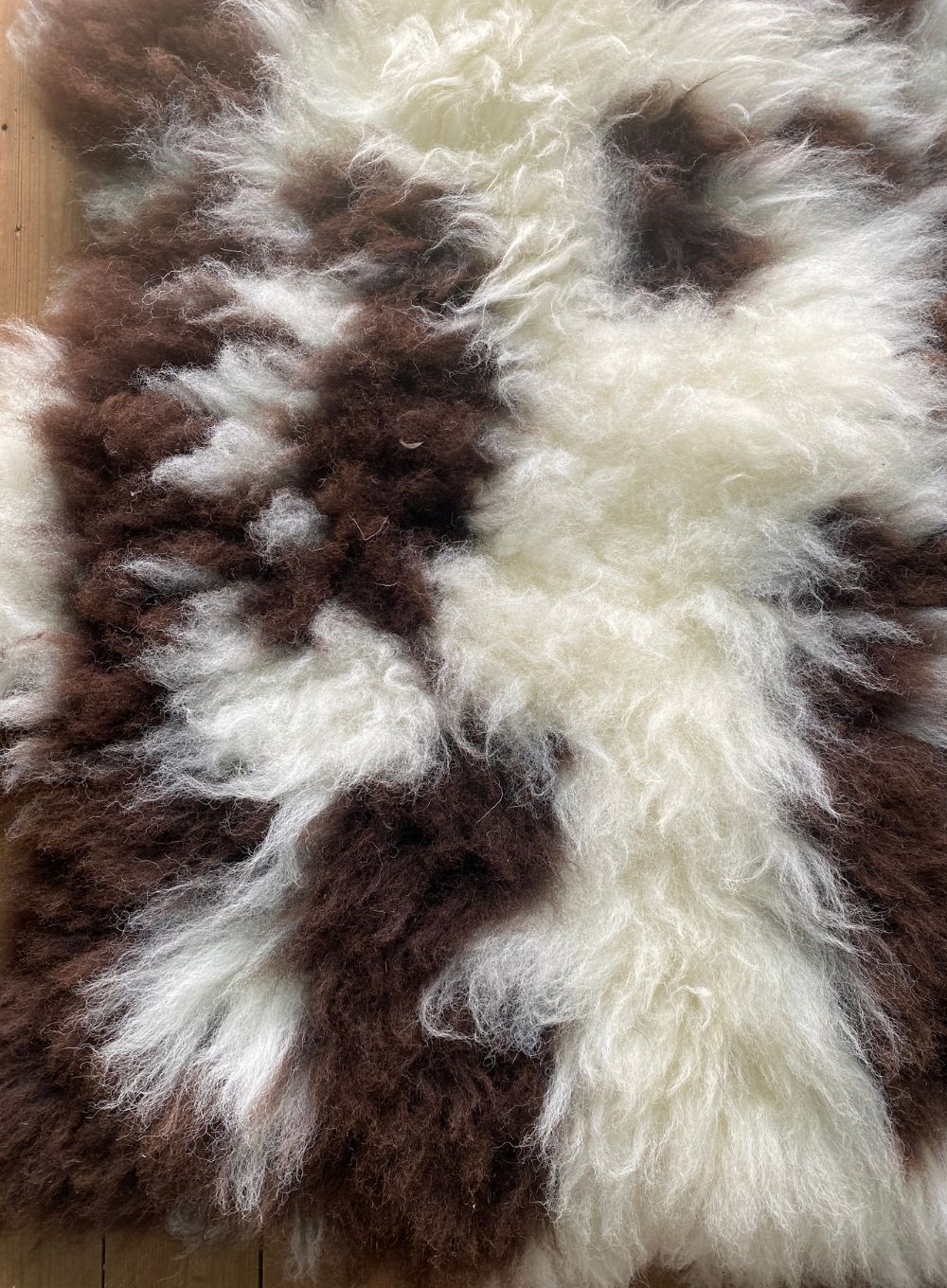 Cream and brown spotty sheepskin rug close up 