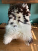 Cream and brown spotty sheepskin rug on chair