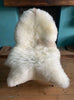 Cream sheepskin rug on chair 