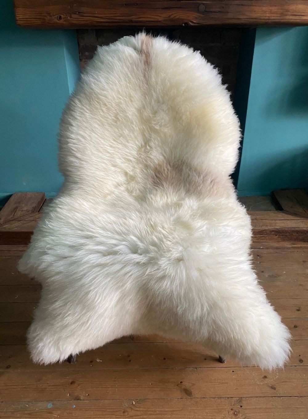Cream sheepskin rug on chair 