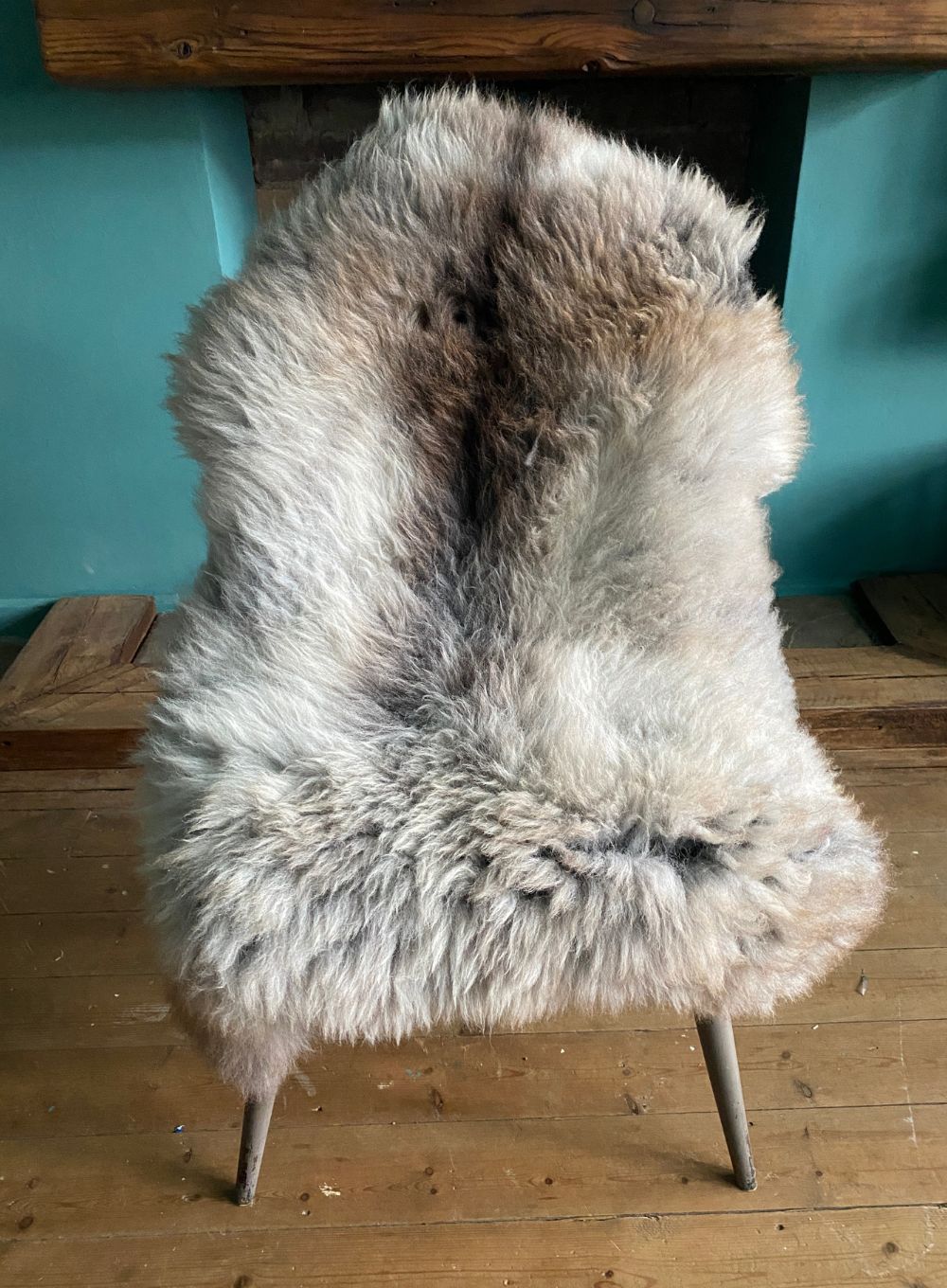 Brown and grey sheepskin rug on chair 