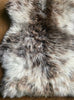 Cream and brown speckled sheepskin rug close up