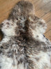 Cream and brown speckled sheepskin rug close up