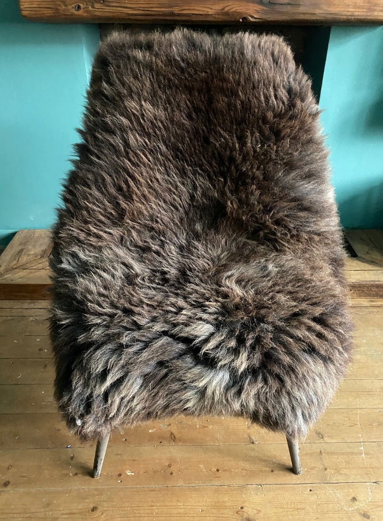 Brown sheepskin rug on chair 