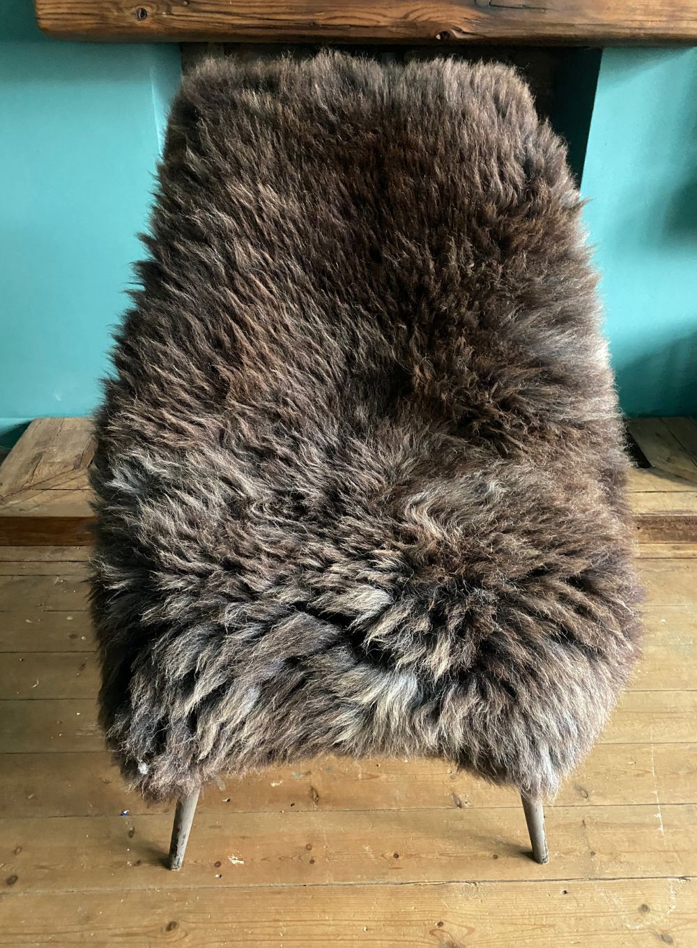 Brown sheepskin rug on chair 