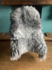 Grey sheepskin rug on chair